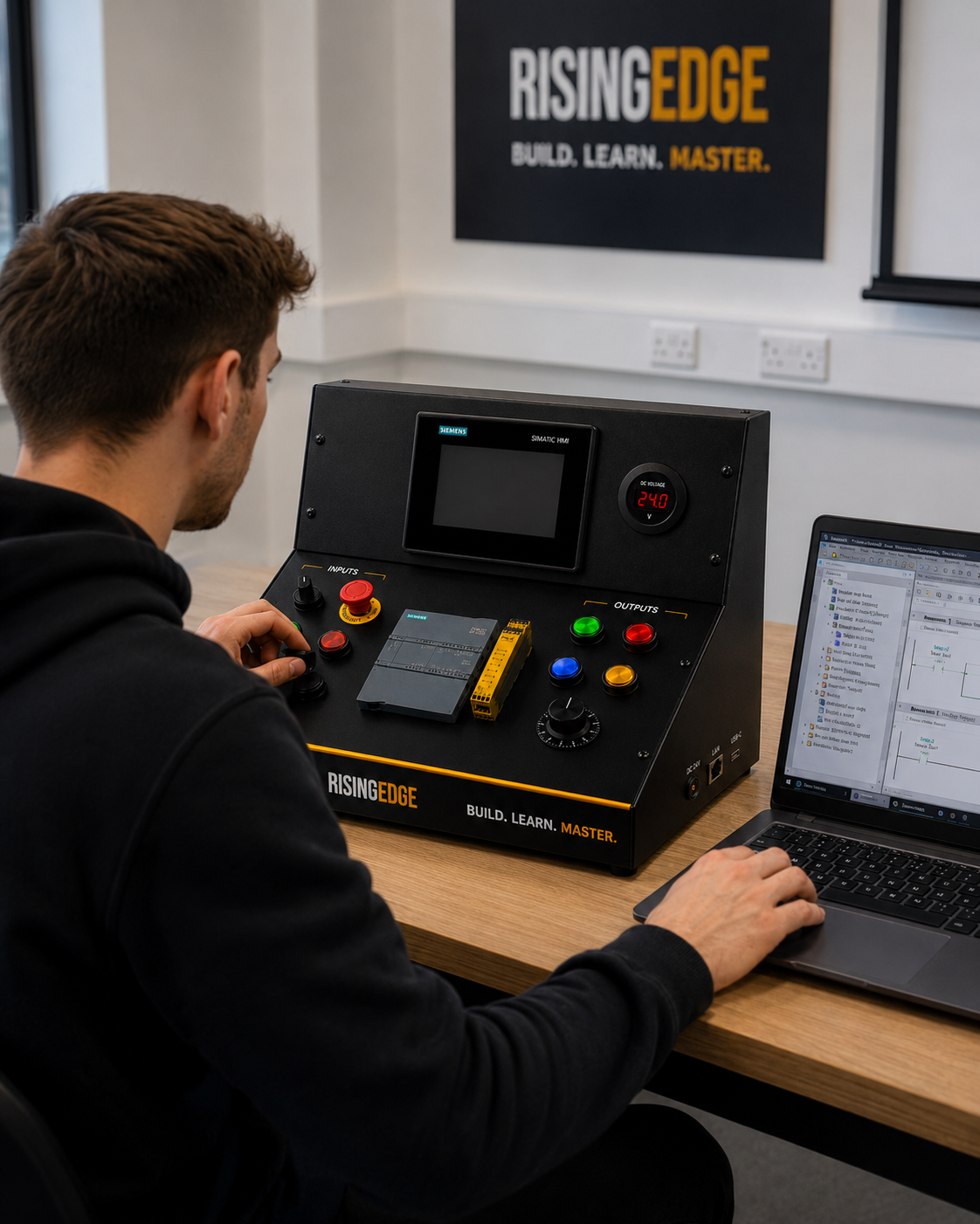 Learner using a hands-on PLC training kit for industrial automation practice